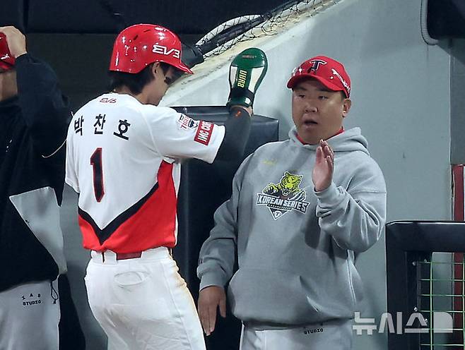 [광주=뉴시스] 김명년 기자 = 28일 광주 북구 광주-기아챔피언스필드에서 열린 2024 KBO 포스트시즌 한국시리즈 5차전 삼성 라이온즈와 KIA 타이거즈의 경기, 1회말 1사 주자 1,3루 상황에서 3루주자 KIA 박찬호가 KIA 나성범의 희생플라이때 홈으로 쇄도해 득점에 성공한 후 이범호 감독과 하이파이브를 하고 있다. 2024.10.28. kmn@newsis.com