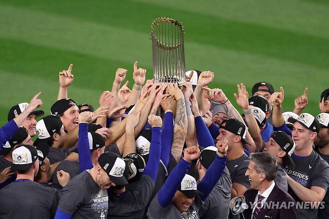 2024 MLB WS 우승 트로피를 맞잡은 다저스 선수단 [게티이미지/AFP=연합뉴스]