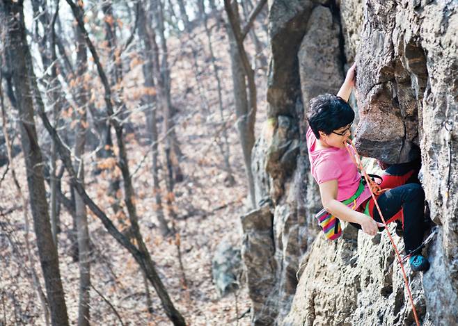 '-5.10'(5.11b/d) 루트 오버행 등반을 앞두고, 로프를 퀵드로에 걸기 위해 입에 물어 당기는 유옥준.