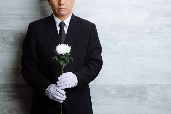 White lilies and chrysanthemums are the standard funeral flowers in Korea. [GETTY IMAGES BANK]