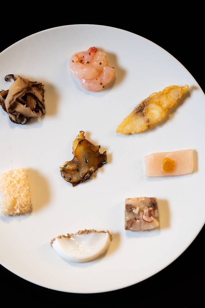 Yun Seoul’s Gakseok Eochae: Inspired by traditional names for seafood dishes, this plate features shiitake mushrooms, scallop and dried scallop, octopus with perilla, veal shank terrine, aged Spanish mackerel with pickled garlic, fish jeon, sweet shrimp with native perilla, and, at the center, abalone-based jang (sauce). /Yun Seoul
