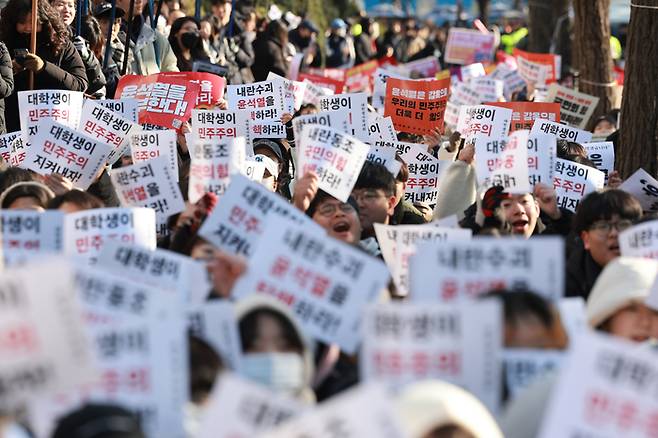 7일 오후 서울 영등포구 여의도 산업은행 본점 인근에서 열린 ‘윤석열 퇴진 대학생 시국대회’에서 대학생들이 비상계엄을 선포한 대통령의 퇴진을 촉구하며 손팻말을 흔들고 있다. [연합뉴스]