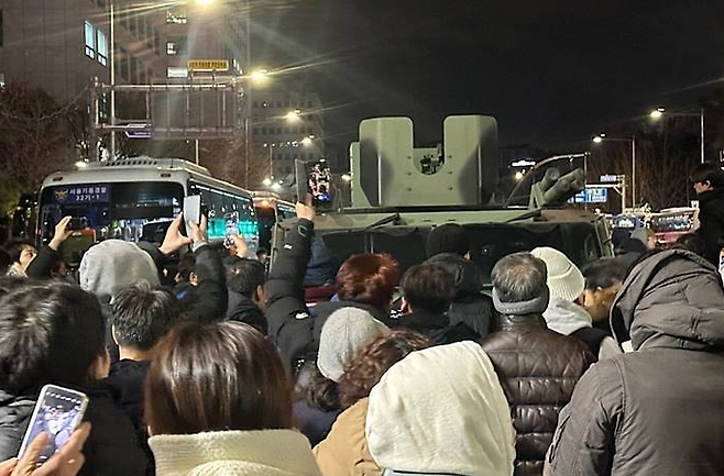 지난 3일~4일 밤 시민들이 국회 앞으로 출동한 계엄군의 장갑차를 막아 세우고 있다. [온라인 캡처]