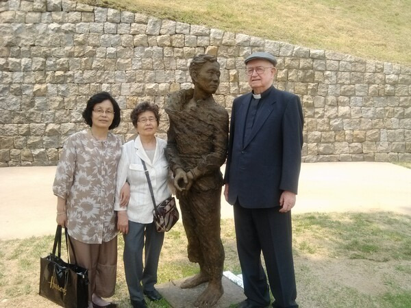 2012년 서대문형무소에서 열린 ‘인혁당 전시회’에서 인혁당 희생자 이수병 선생 부인 이정숙(왼쪽부터)씨, 김용원 선생 부인 유승옥씨, 시노트 신부가 김서경 김운성 작가가 제작한 ‘사형수상’을 사이에 두고 사진을 찍고 있다.                  이창훈 제공