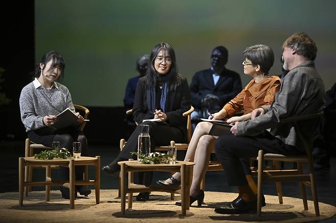 South Korean author Han Kang (second from left) reads on stage at The Royal Dramatic Theatre in Stockholm, Dec. 12. (AP-Yonhap)