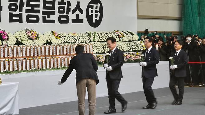 이재명(왼쪽 두 번째) 더불어민주당 대표가 30일 전남 무안종합스포츠파크에 설치된 제주항공 여객기 사고 희생자 합동분향소를 찾아 헌화하고 있다. 왼쪽 세 번째는 김영록 전남지사, 왼쪽 네 번째는 강기정 광주시장. /정두용 기자