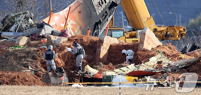 제주항공 여객기 참사 7일째인 4일 오후 전남 무안국제공항 참사 현장에서 항공·철도사고 조사위원회(ARAIB) 관계자들이 제주항공 7C2216편의 엔진이 파묻혀있던 로컬라이저(방위각시설) 둔덕을 살펴보고 있다. 2025.1.4/뉴스1 ⓒ News1 김진환 기자