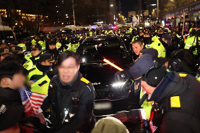 내란 우두머리 혐의로 체포된 윤석열 대통령의 구속 전 피의자심문(영장실질심사)이 종료된 1월18일 서울 마포구 공덕역 인근에서 윤 대통령 지지자들이 고위공직자범죄수사처(공수처) 관계자들이 탄 차량의 앞을 막고 구호를 외치고 있다. ⓒ 연합뉴스