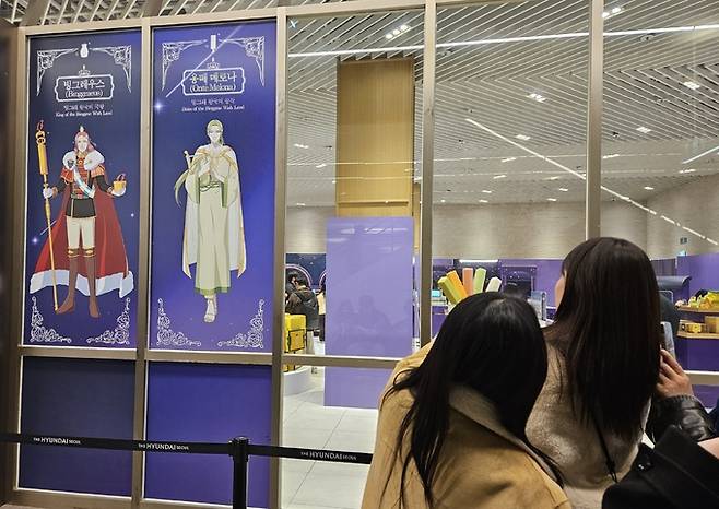 수출 전용 메로나를 들고 빙그레우스 캐릭터와 사진을 찍는 방문객들.