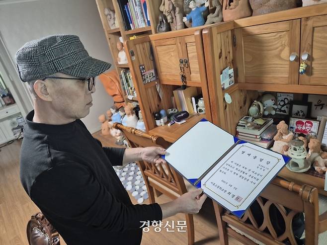 정성재씨가 지난 13일 정유엽군의 고등학교 명예 졸업장을 보여주고 있다. 반기웅 기자