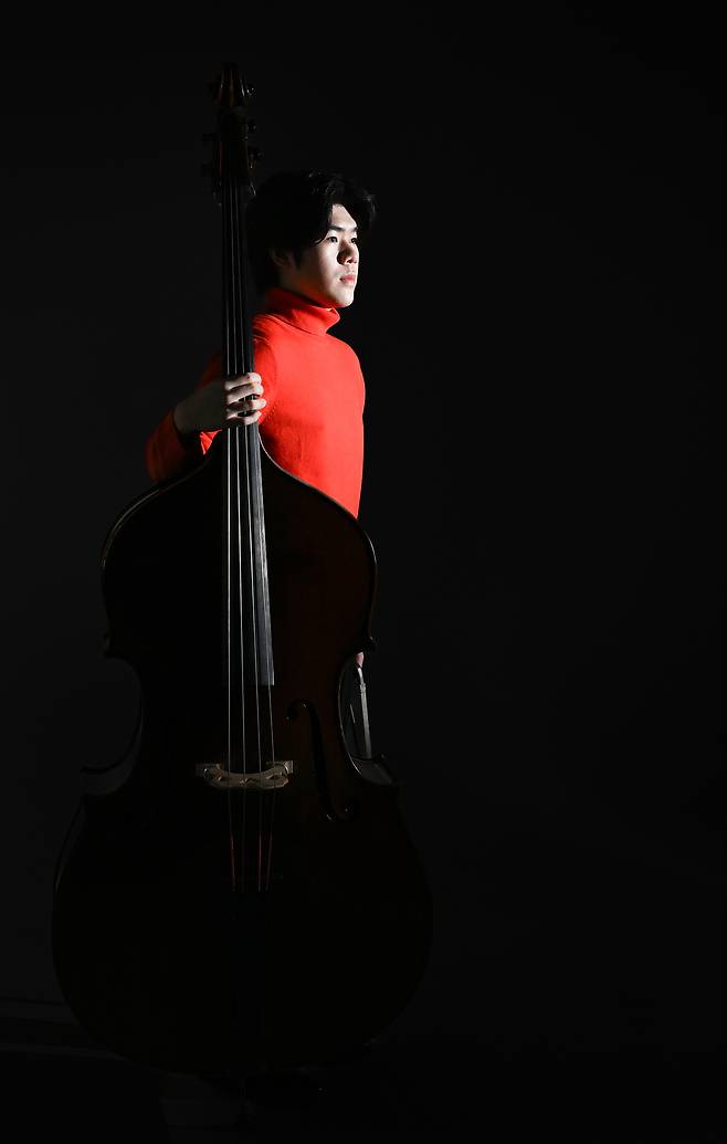 Double bassist Ryu Si-heon poses for photos during an interview with The Korea Herald on Dec. 26, 2024. (Lee Sang-sub/The Korea Herald)