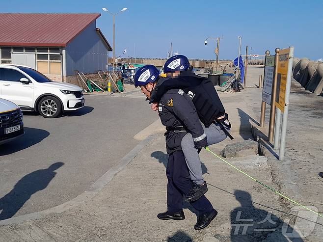 풍랑특보 속 테트라포드에 고립된 30대 남성 구조하는 속초해경 소속 경찰관.(속초해경 제공) 2025.2.3/뉴스1