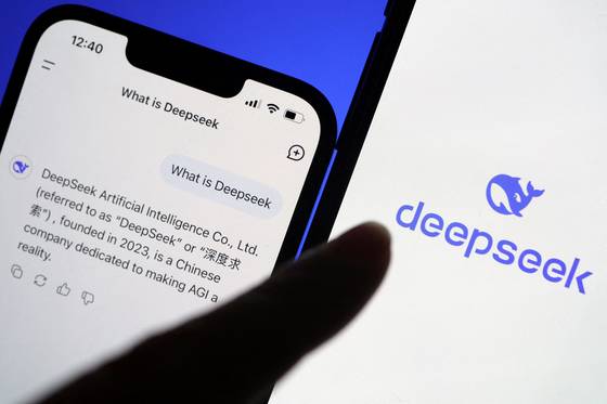 The logo of DeepSeek is displayed alongside its AI assistant app on a mobile phone, in this illustration picture taken Jan. 28, 2025. [REUTERS/YONHAP]