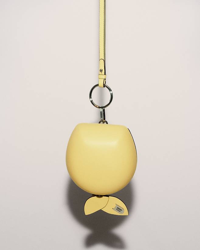 La Pomme Crossbody, an apple-shaped small leather bag which pays tribute to ″Les Jeunes Amours″ (1963), or ″The Young Loves,″ by Belgian Surrealist artist Rene Magritte (1898-1967). [DELVAUX]