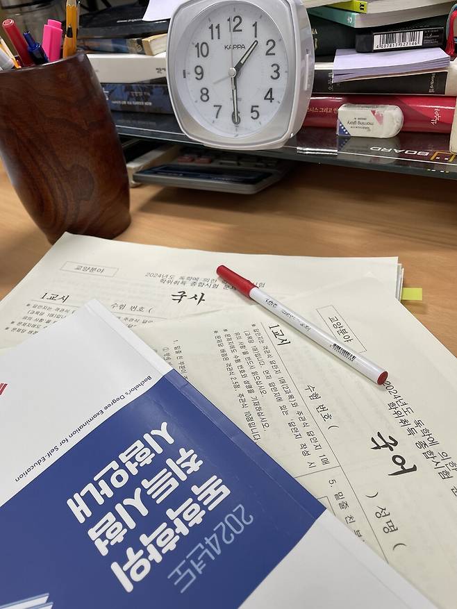 지난해 독학학위 취득 시험 안내 책자와 시험 문제. 김지원(가명)씨는 ‘독학학위제’가 제2 인생을 위한 토대가 된다고 이야기한다. 김지원씨 제공