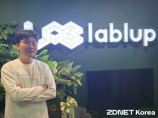 신정류 래블업 대표가 회사 CI를 배경으로 포즈를 취했다.