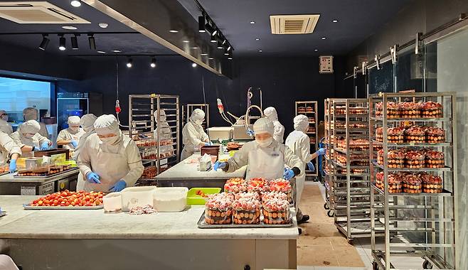 대전 중구 ‘성심당 케익부띠크’ 옆 별도의 케이크 수령 매장에서 직원들이 딸기를 손질하고 있다.