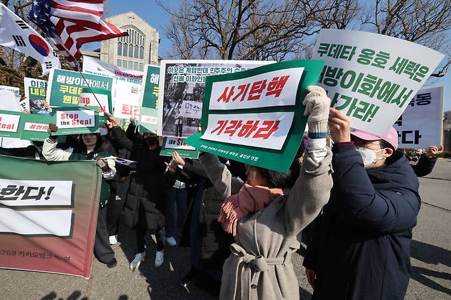 26일 오전 서울 서대문구 이화여대 대강당 앞에서 자유민주주의를 수호하는 이화인 연합 회원들과  이화여대 긴급행동을 준비하는 재학생 졸업생들이 각각 탄핵 반대와 윤 대통령 파면을 촉구하는 손팻말을 들고 시위를 하고 있다. 김태형 기자 xogud555@hani.co.kr