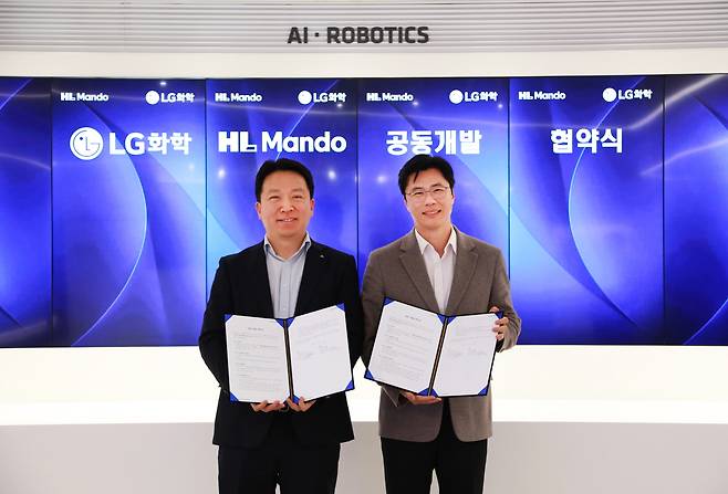 고경덕(오른쪽) LG화학 전자소재 사업부장 상무와 최한규 HL만도 센터장 상무가 업무협약식을 마치고 기념 촬영을 하고있다./사진=LG화학