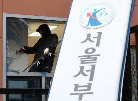 한 작업자가 지난 1월 19일 윤석열 대통령 지지자들인 폭도들이 폭동을 일으킨 서울서부지방법원에서 복구 작업을 하고 있다. (사진=연합뉴스)