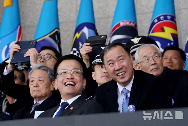 [청주=뉴시스] 조수정 기자 = 최상목(앞 왼쪽) 대통령 권한대행 부총리 겸 기획재정부 장관이 12일 청주 공군사관학교에서 열린 제73기 졸업 및 임관식에서 블랙이글스 축하비행을 보고 있다. 앞 오른쪽은 최병옥 대통령실 국방비서관. (대통령실통신사진기자단) 2025.03.12. chocrystal@newsis.com