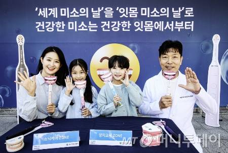 필립스 소닉케어가 ‘세계 미소의 날’을 맞이해 2일 서울 중구 한국은행 앞 분수 광장에서 대한구강보건협회와 함께 건강한 잇몸 미소를 위한 올바른 양치 습관을 알리는 행사를 진행했다. 박용덕 대한구강보건협회 회장(오른쪽 첫 번째)과 모델들이 잇몸 미소를 지으며 올바른 양치법을 소개하고 있다./사진=필립스코리아, 뉴스1