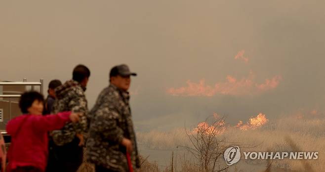 '발만 동동' (의성=연합뉴스) 윤관식 기자 = 경북 의성군 대형 산불 발생 사흘째인 24일 의성군 점곡면 야산에서 산불이 강풍을 타고 번지자 인근 주민들이 걱정하고 있다. 2025.3.24 psik@yna.co.kr