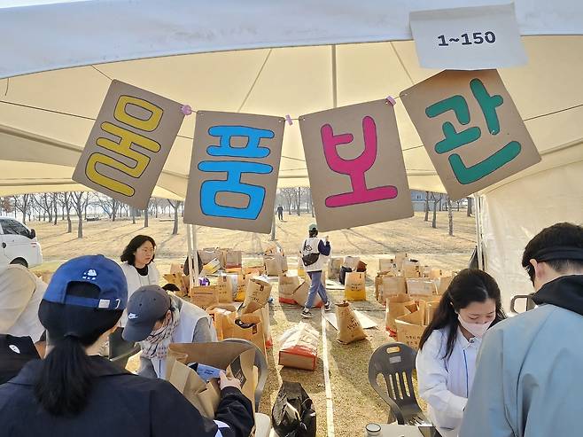 23일 오전 서울 여의도 한강공원에서 열린 ‘2025 무해런’ 현장. 물품보관소에서는 흔히 쓰는 비닐백 대신 재사용 종이봉투가 제공됐다. 안내판은 종이상자를 재활용해 만들었다. 김광우 기자.
