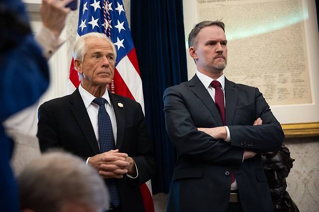 White House Senior Counselor for Trade and Manufacturing Peter Navarro (left) and US Trade Representative Jamieson Greer look on as US President Donald Trump delivers remarks on auto tariffs and other topics in the Oval Office at the White House on Wednesday.  (Pool Photo  via EPA)