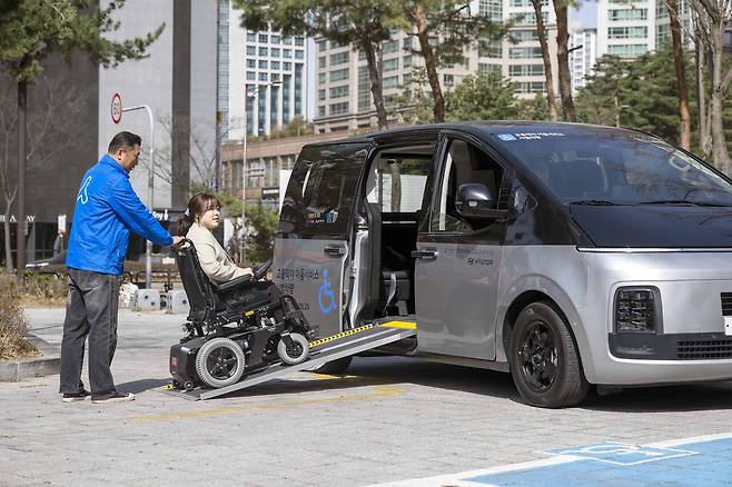 승객이 차량의 옆문으로 탑승하는 모습
