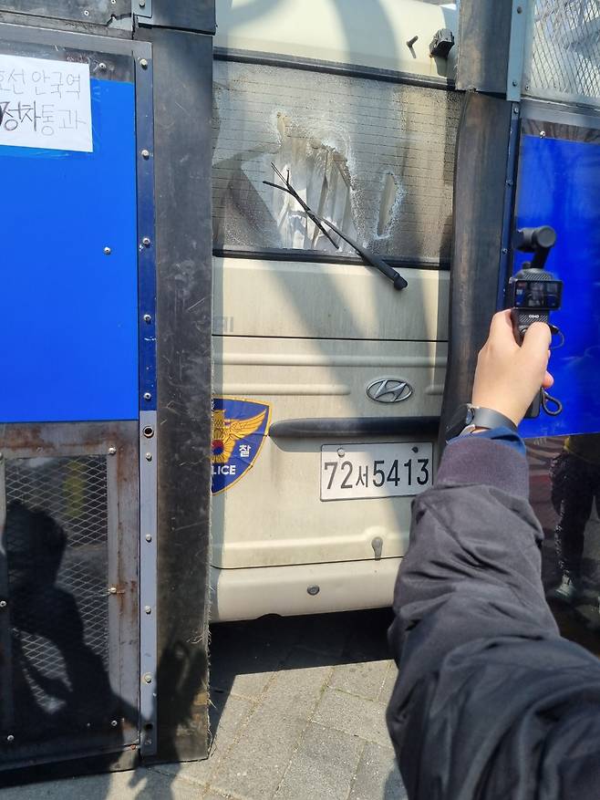 A glass window on a police bus lies shattered near Anguk Station in central Seoul after a pro-Yoon Suk Yeol protesters smashed it after hearing the Constitutional Court's ruling on Apr. 4.