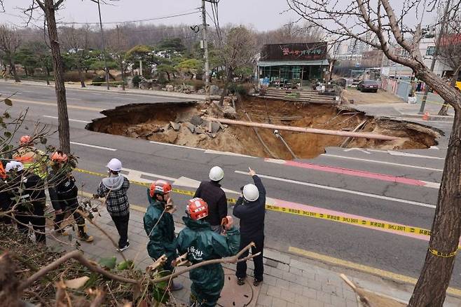 지난달 25일 강동구 대명초등학교 도로에서 전날 발생한 대형 땅꺼짐 현장의 모습. 연합뉴스