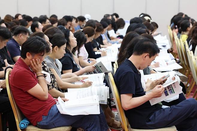지난해 7월21일 서울 광진구 세종대에서 열린 ‘종로학원 2025대입 수시, 정시 지원전략 특집 설명회’를 찾은 학부모들이 입시 자료를 살펴보고 있다. 한겨레 자료