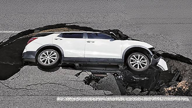 지난해 8월 서울 서대문구 연희동 성산로에 가로 6m, 세로 4m, 깊이 2.5m의 싱크홀이 발생해 승용차 한 대가 빠져 있는 모습. /연합뉴스