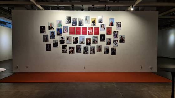 International students at the Korea National University of Arts that were recipients of the AMA+ scholarship hang graduation photographs inside the school in Seongbuk District, central Seoul, on Feb. 5. [KOREA NATIONAL UNIVERSITY OF ARTS]