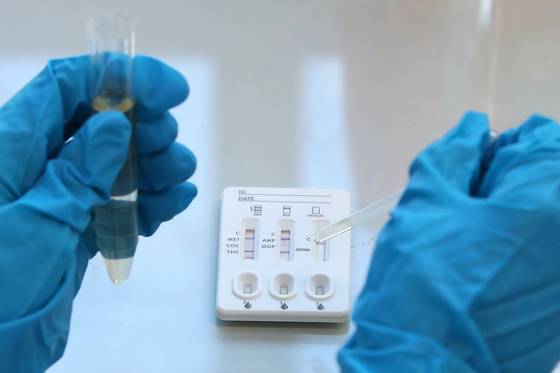 A health official conducts a drug test at a facility in Daegu on Feb. 24. [NEWS1]