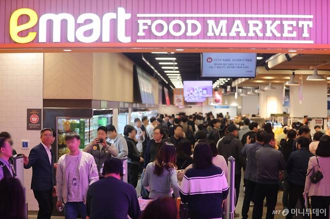 (서울=뉴스1) = 이마트가 17일 서울 강동구 고덕비즈밸리에 한층 진화한 미래형 리테일 매장 '이마트 푸드마켓 고덕점'을 그랜드 오픈했다고 밝혔다.  사진은 이마트 푸드마켓 고덕점 입장하는 고객들 모습. (이마트 제공. 재판매 및 DB 금지) 2025.4.17/뉴스1  Copyright (C) 뉴스1. All rights reserved. 무단 전재 및 재배포,  AI학습 이용 금지. /사진=(서울=뉴스1)