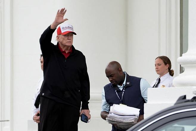 도널드 트럼프 미국 대통령이 20일(현지시간) 백악관을 나서며 손을 흔들고 있다. 연합뉴스