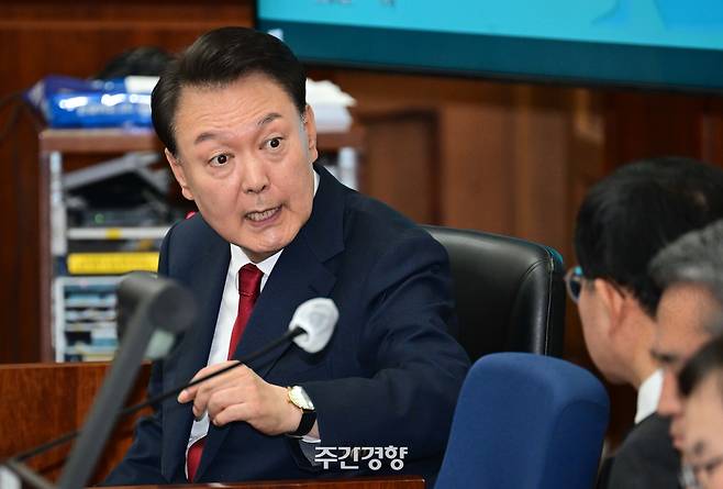 12·3 불법계엄을 선포해 내란 우두머리 혐의로 재판에 넘겨진 윤석열 전 대통령이 21일 오전 서울 서초구 서울중앙지법 417호 법정에 앉아 변호인단과 대화를 하고 있다. 이준헌 기자