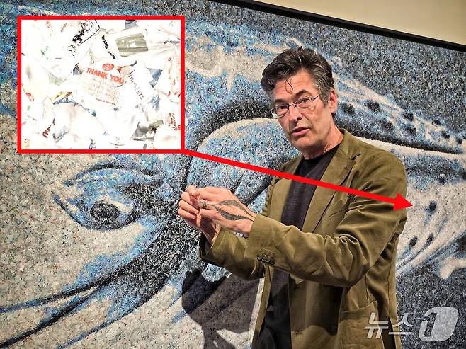 사진작가 크리스 조던이 21일 서울 중구 충무아트센터에서 열린 기후위기 사진전 '더 글로리어스 월드'에서 연작 '숫자의 초상'(Running the Numbers) 중 '고래'(Whale)을 설명하고 있다. 이 사진은 플라스틱 쓰레기 봉투 5만개를 합성해 제작했다. ⓒ 뉴스1 황덕현 기자