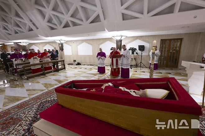 [바티칸시티=AP/뉴시스]21일 서거한 프란치스코 교황의 시신이 바티칸의 교황 개인 예배당에 놓인 관에 안치돼 있다. 바티칸은 피에트로 패롤린 국무장관이 교황 시신이 안치된 관 앞에서 추모 기도를 올리는 사진을 교황 선종 후 처음으로 공개했다. 2025.04.22.