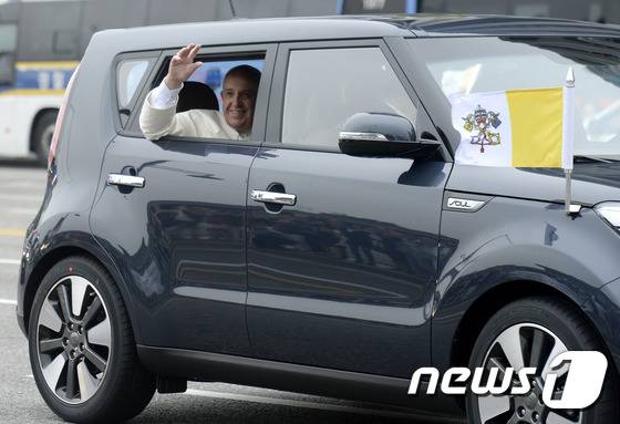 4박 5일 일정으로 한국을 방문한 프란치스코 교황이 14일 오전 서울공항에서 광화문을 거쳐 주한 교황 대사관으로 향하는 중 기아차 쏘울에 탑승해 시민들을 향해 손을 흔들고 있다. 프란치스코 교황은 취임 초기부터 방탄차를 이용하지 않겠다고 공언했으며, 실제 이번 한국 방문 때도 가장 작은 차를 타고 싶다는 뜻을 한국 천주교 교황방한준비위원회에 전달해온 것으로 알려졌다. 이에 따라 방한 기간 중 교황은 기아자동차의 1600cc급 소형 승용차인 쏘울을 탄다.2014.8.14/뉴스1 ⓒ News1 안은나 기자