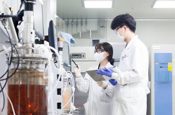 SK bioscience researchers analyze their findings in a photo shared by the company on Feb. 12. [YONHAP]