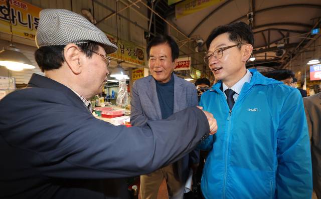 김경수 더불어민주당 대선 경선 후보가 22일 광주 서구 양동시장을 방문해 지지자와 악수를 하고 있다. 뉴스1