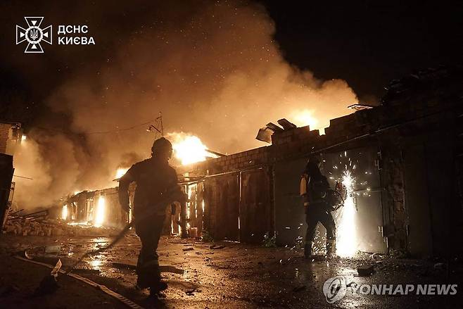 24일(현지시간) 러시아의 미사일 공격으로 불타는 우크라이나 키이우 건물.  [AFP 연합뉴스]