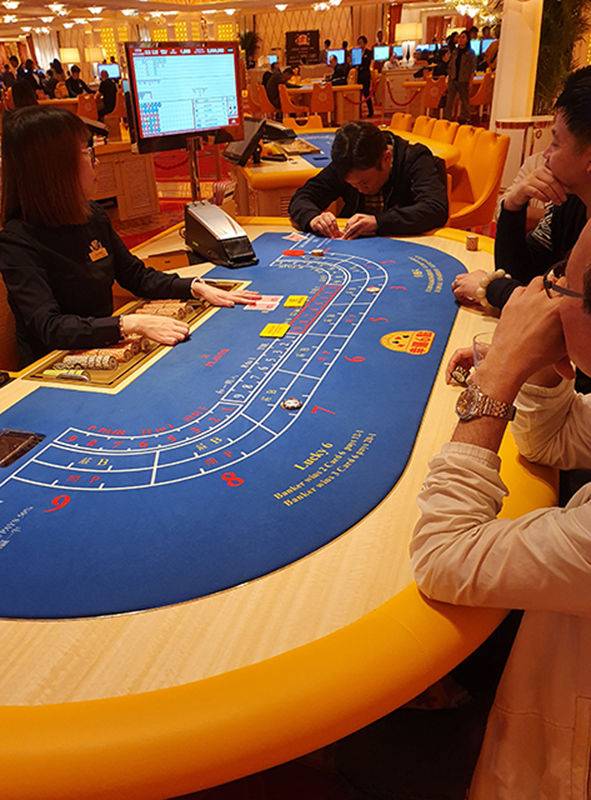 마카오 카지노의 바카라 테이블. 한 고객이 바카라 게임에서 카드를 진지하게 살펴보고 있다.(사진=뉴시스) *재판매 및 DB 금지