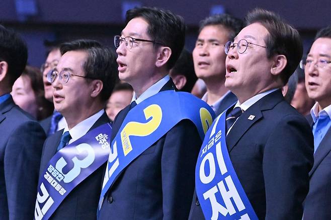 26일 오후 광주 서구 김대중컨벤션센터에서 열린 더불어민주당 21대 대통령선거 후보자 선출을 위한 호남권 합동연설회에서 김동연(왼쪽부터), 김경수, 이재명 후보가 애국가를 부르고 있다. 2025.04.26 뉴시스