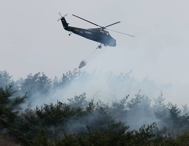 지난달 27일 산불이 발생한 울산시 울주군 온양읍에서 진화 작업을 하는 시 임차 헬기가 연기 속으로 진입하고 있다. [연합]