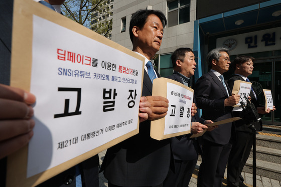 더불어민주당 이재명 전 대표의 대선 예비후보 캠프 소속 의원들이 지난 16일 서울경찰청 민원실에서 이 전 대표의 딥페이크 영상 유포 혐의를 받는 유튜버 등을 공직선거법 위반죄로 고발하고 있다. 연합뉴스