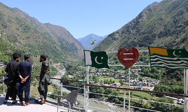 관광객들이 27일 파키스탄령 카슈미르의 닐룸 밸리에서 인도령 카슈미르를 내려다보며 서있다. EPA 연합뉴스